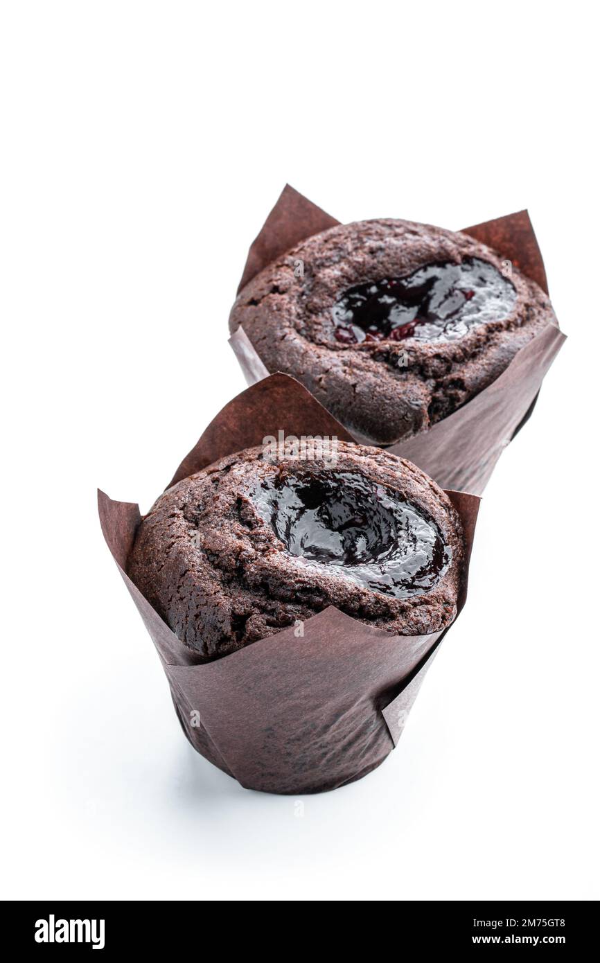 Dark chocolate muffin stuffed with jam isolated on white Stock Photo