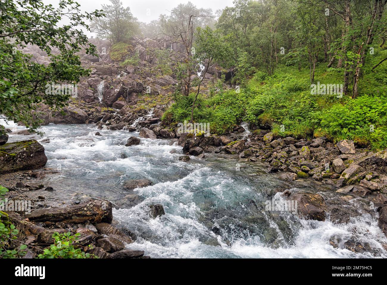 Wild river Rauma, hiking trail Trollstigfoten, fog landscape, Norway ...