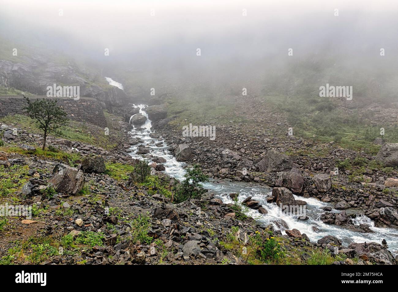Wild river Rauma, hiking trail Trollstigfoten, fog landscape, Norway ...