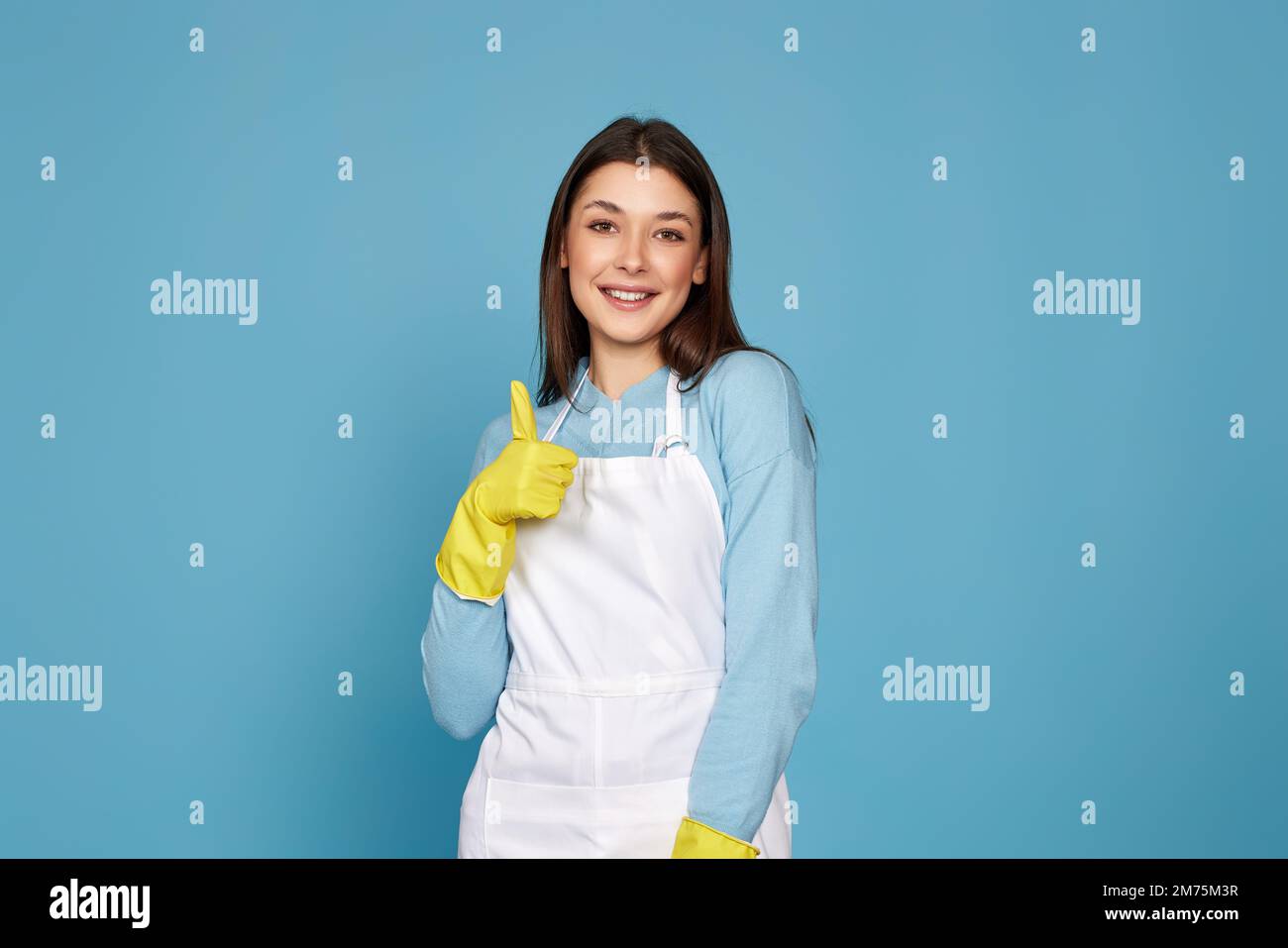 woman in rubber gloves and cleaner apron showing ok sign Stock Photo ...