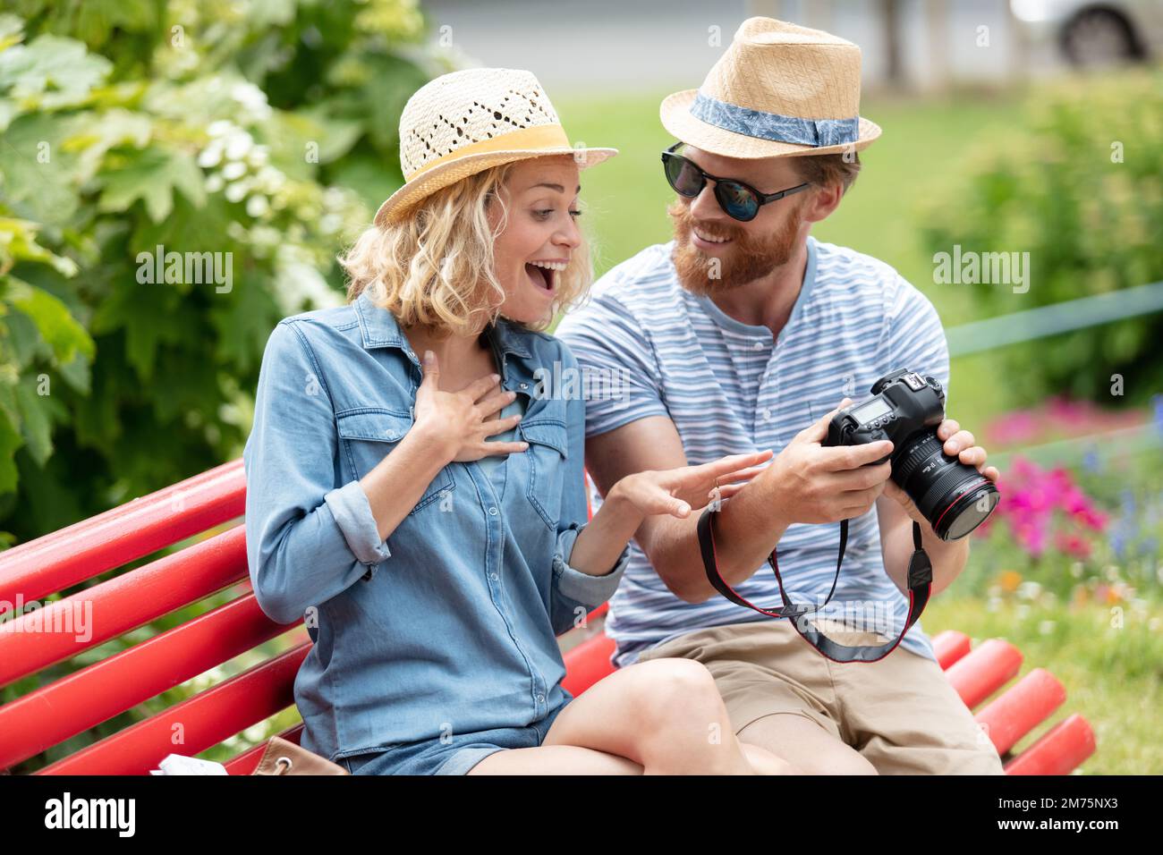 happy young couple in love sitting on a park bench Stock Photo - Alamy