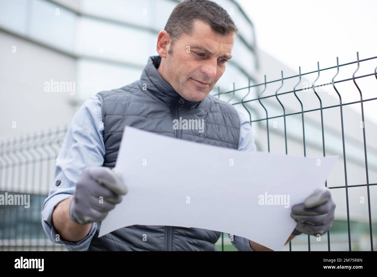 architect or engineer holding looking project blueprint papers Stock Photo
