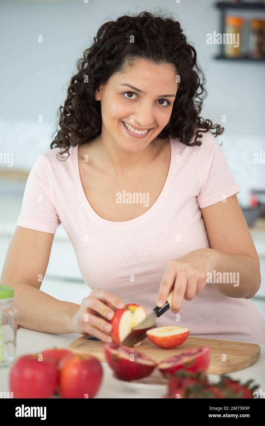 woman cutting apples at home Stock Photo