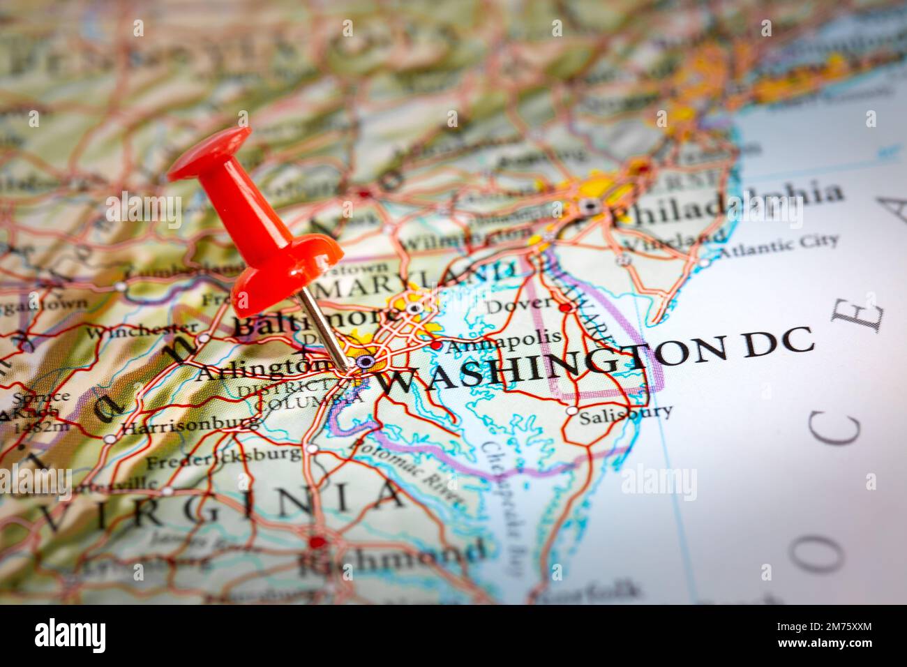 A push pin on a map of North America marking the location of the capital city of Washington DC Stock Photo