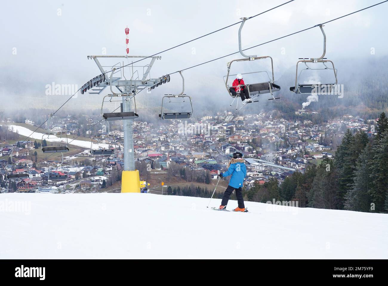 Seefeld, Austria - December 2022: Skiers at the top of the Gschwandtkopf ski slope in Seefeld. Warm weather has caused a snow shortage for many resort Stock Photo
