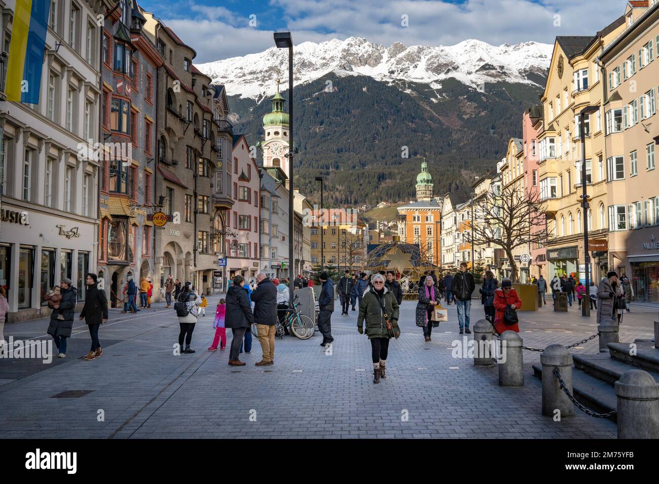 Innsbruck, Austria - December 2022: Main town square off Maria-Theresien-Strasse, Innsbruck. The Hafelekarspitze mountain peak in the background tower Stock Photo