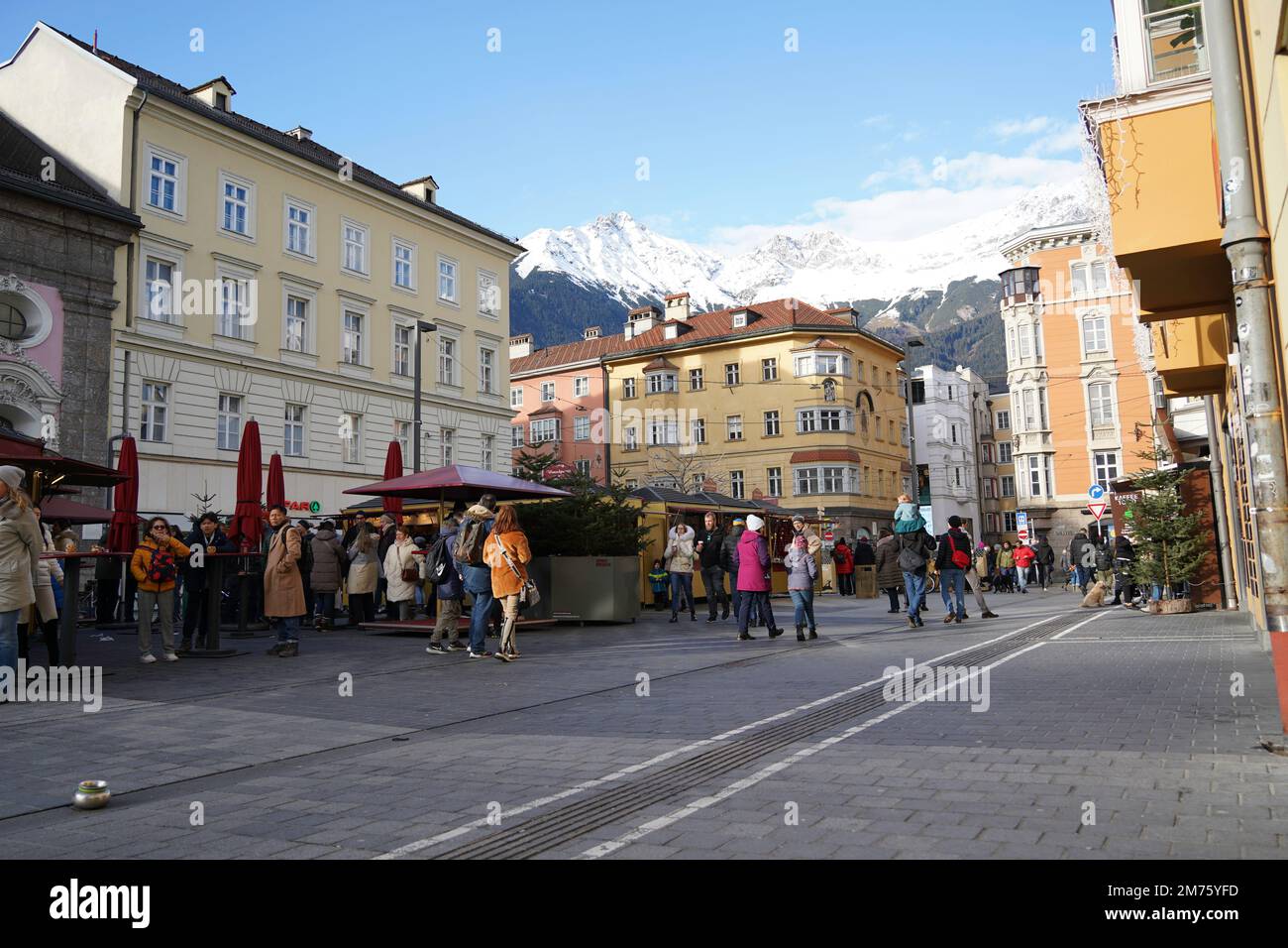 Innsbruck, Austria - December 2022: Main town square off Maria-Theresien-Strasse, Innsbruck. The Hafelekarspitze mountain peak in the background tower Stock Photo