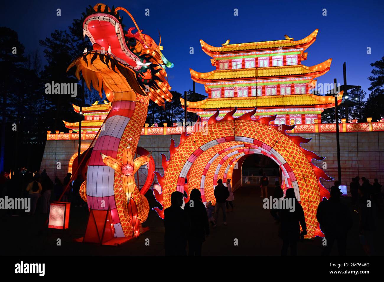 The Dragon Gate and Palace shine brightly as darkness falls at the