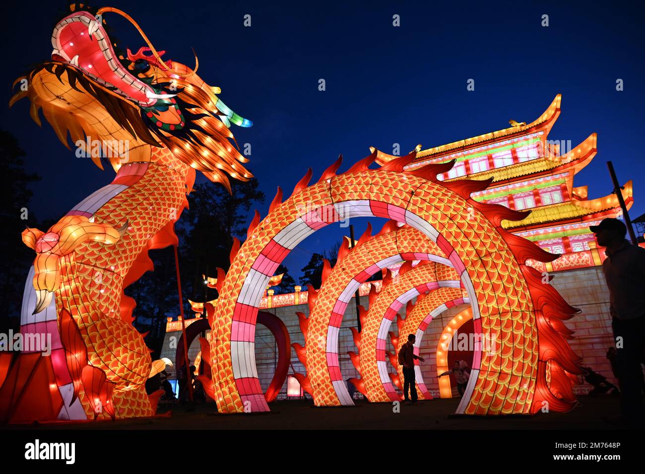 The Dragon Gate and Palace shine brightly as darkness falls at the