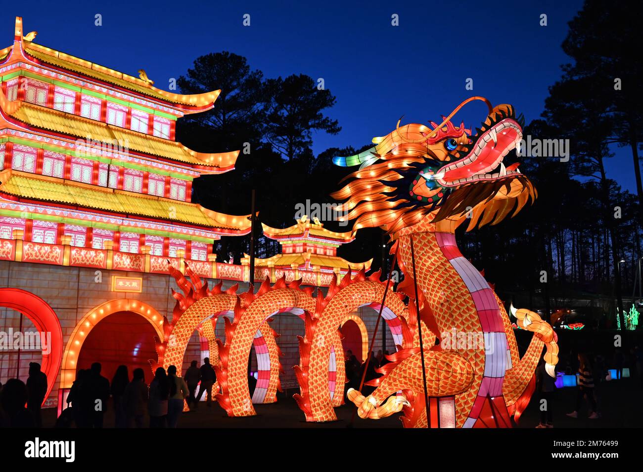 The Dragon Gate and Palace shine brightly as darkness falls at the