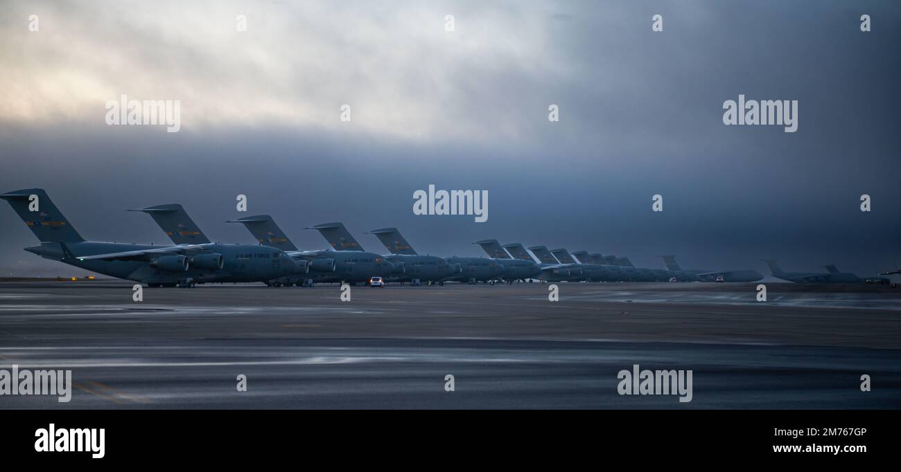 A row of C-17 Globemaster III aircraft stand ready for takeoff during a mission generation exercise at Joint Base Charleston, South Carolina, Jan. 5, 2023. This exercise marked the largest C-17 launch ever from a single base and demonstrated the wing’s ability to rapidly generate and project overwhelming airpower alongside joint partners. (U.S. Air Force photo by Airman 1st Class Christian Silvera) Stock Photo