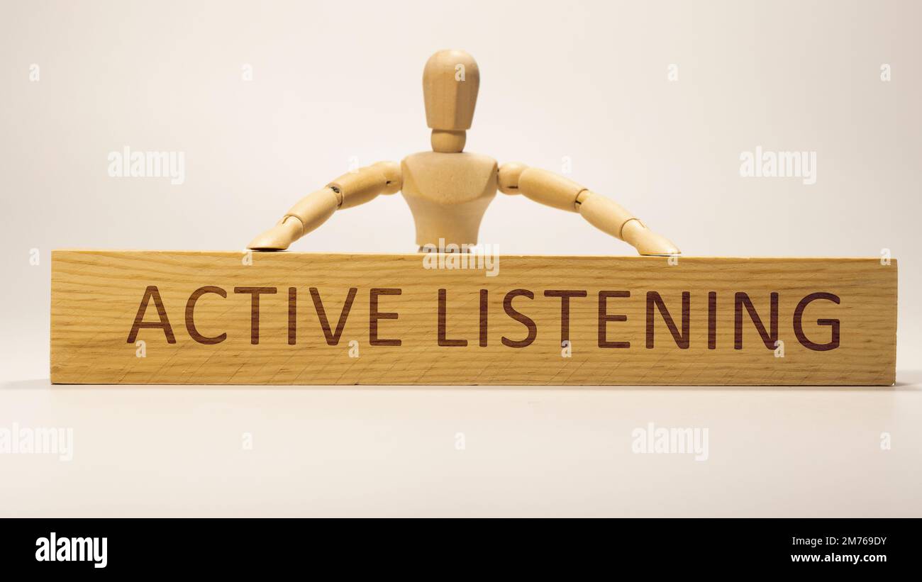 Active Listening is written on the wooden surface. Wooden Concept. Stock Photo