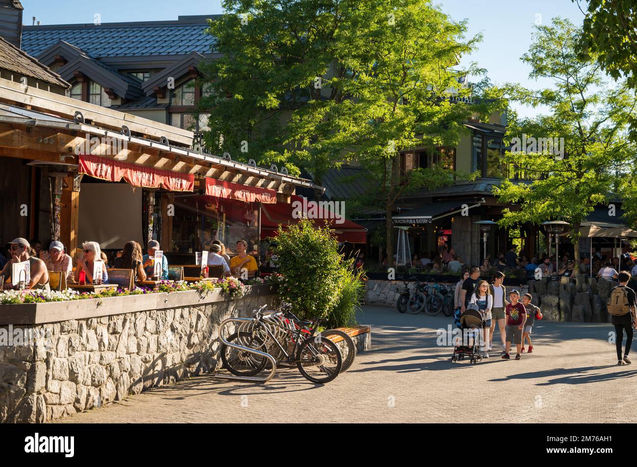 Sidewalk cafes in the Whistler Village town Square on a warm summer evening.  Whistler BC, Canada. Stock Photo