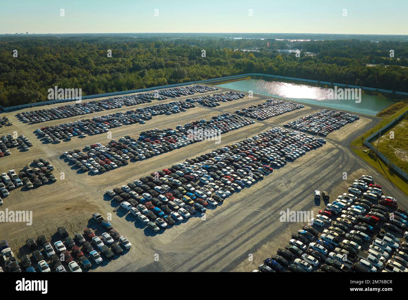 Aerial view of auction reseller company big parking lot with parked