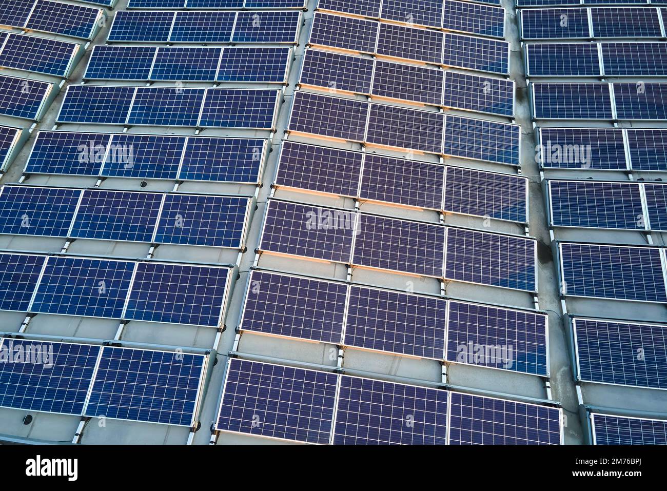 Aerial view of blue photovoltaic solar panels mounted on industrial ...