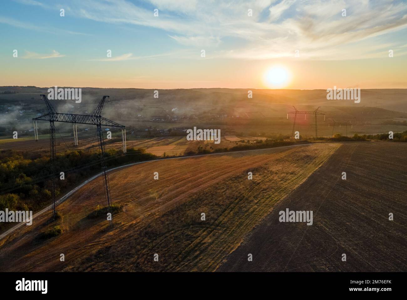High voltage tower with electric power lines at sunset. Transmission of ...