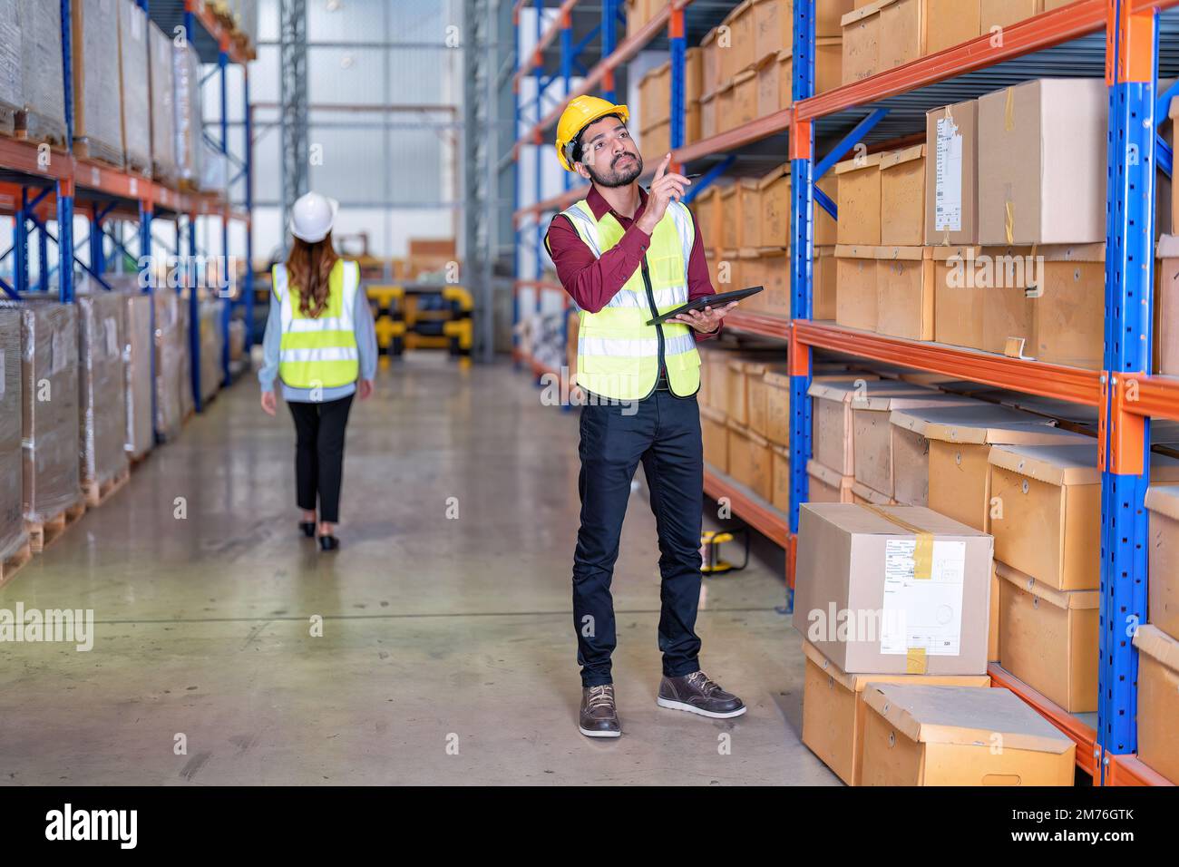 Worker in warehouse hold tablet check list perform inventory stock