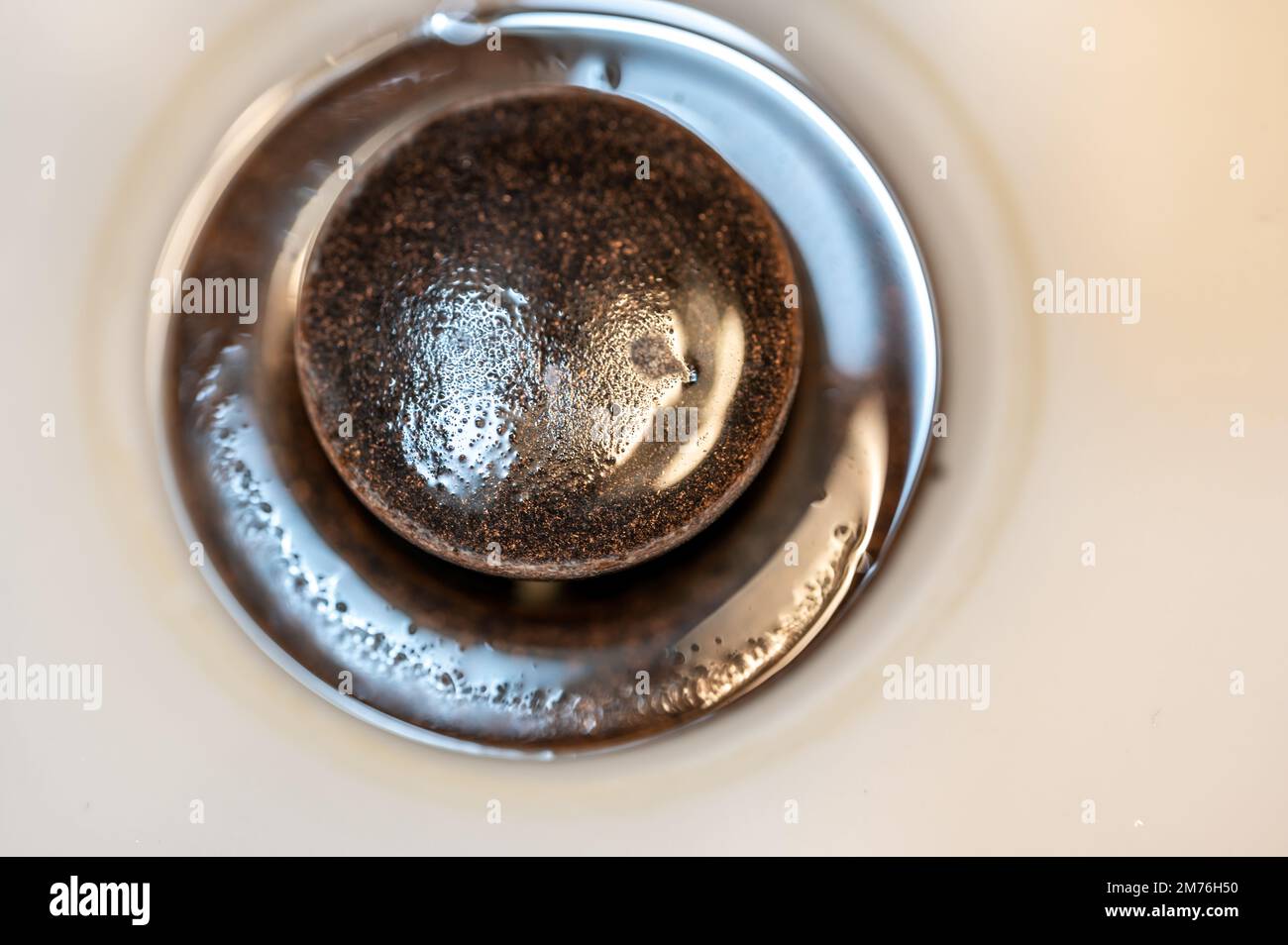 Selective focus on an open bronze sink drain. Stock Photo
