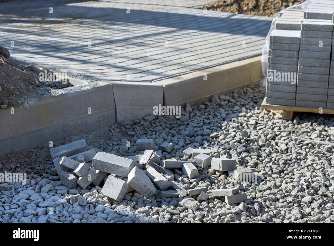 Preparation for laying gray concrete bricks pavers well as pavement