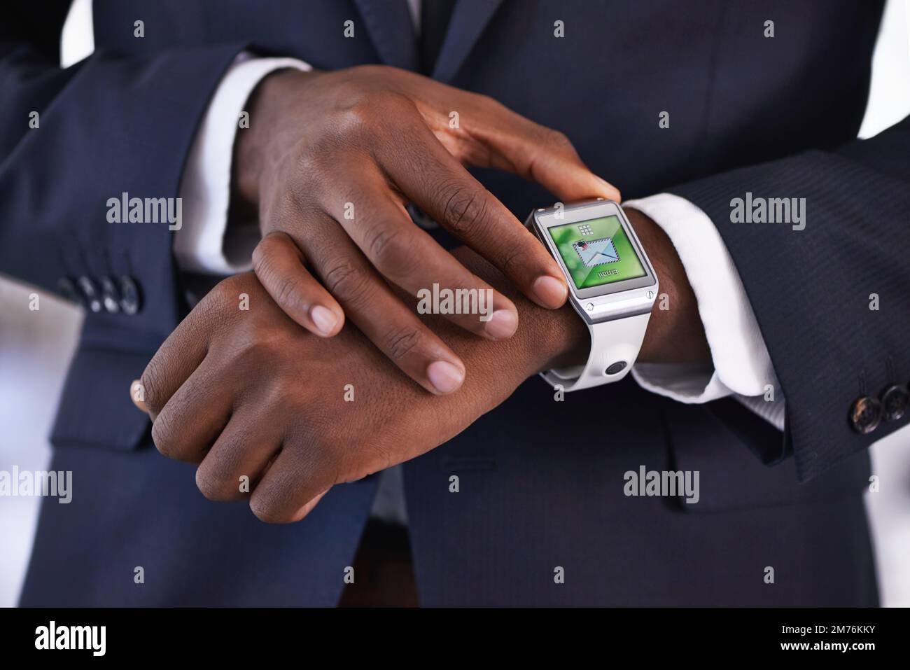 Digital technology just gets smarter and smarter. Cropped view of a young businessman wearing a smartwatch - All screen content is designed by us and Stock Photo