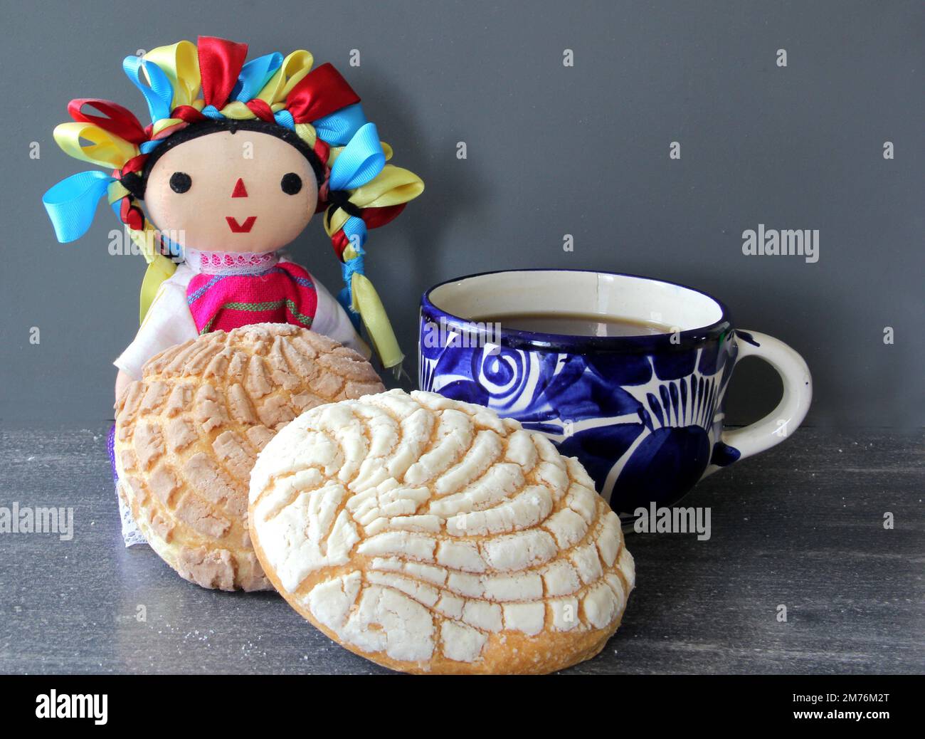 https://c8.alamy.com/comp/2M76M2T/talavera-mug-with-coffee-and-mexican-sweet-bread-and-handmade-doll-2M76M2T.jpg