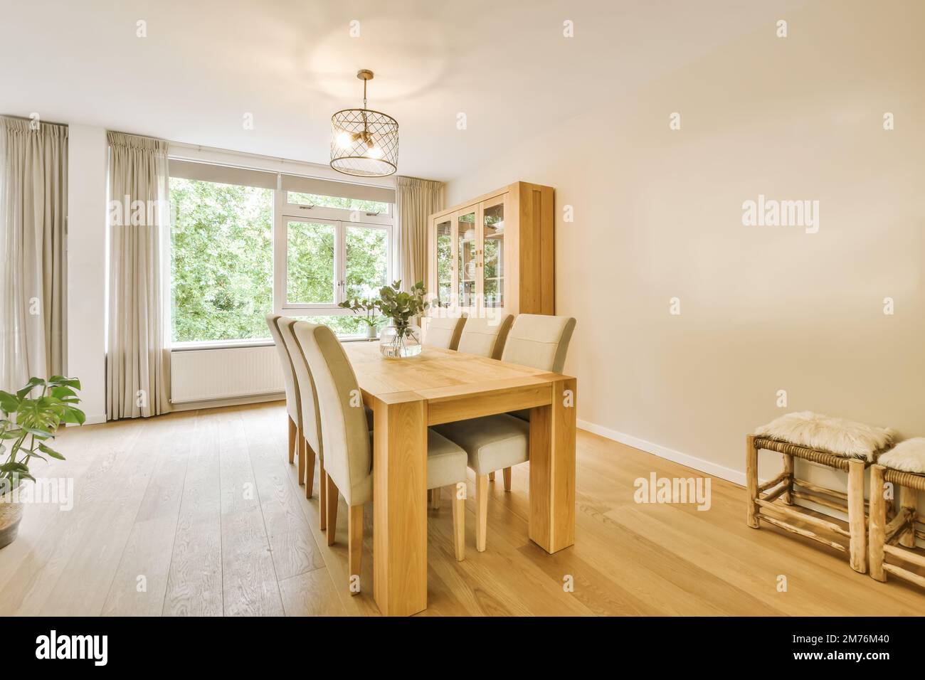 a dining table and chairs in a room with wood floors, white walls and ...
