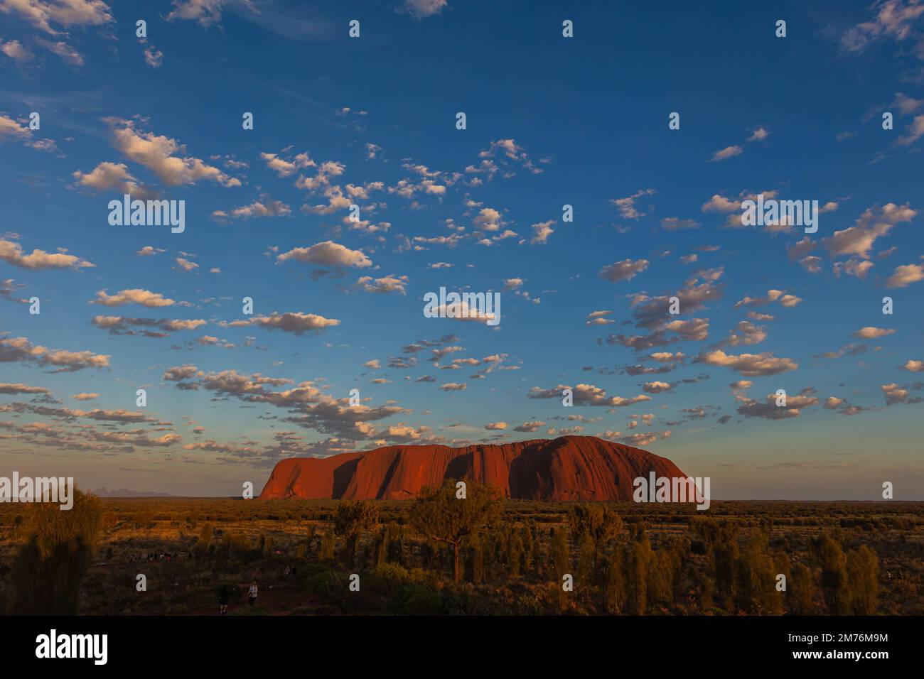 Outback, Australia - November 12, 2022: Sunrise at the Majestic Uluru or Ayers Rock at in the Northern Territory, Australia. The red rock in the cente Stock Photo