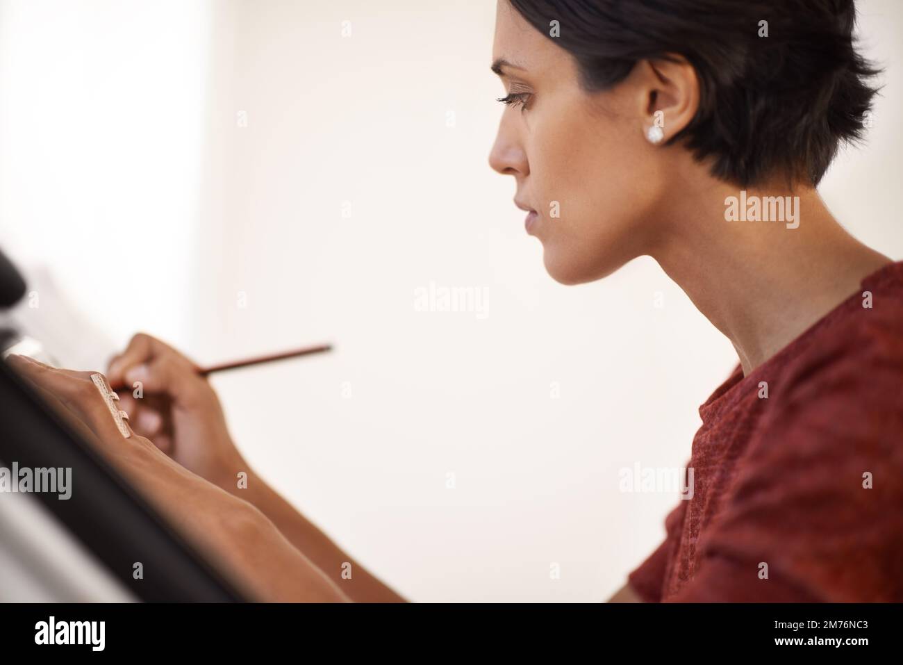 Creating a masterpiece. an attractive young architect working in her ...