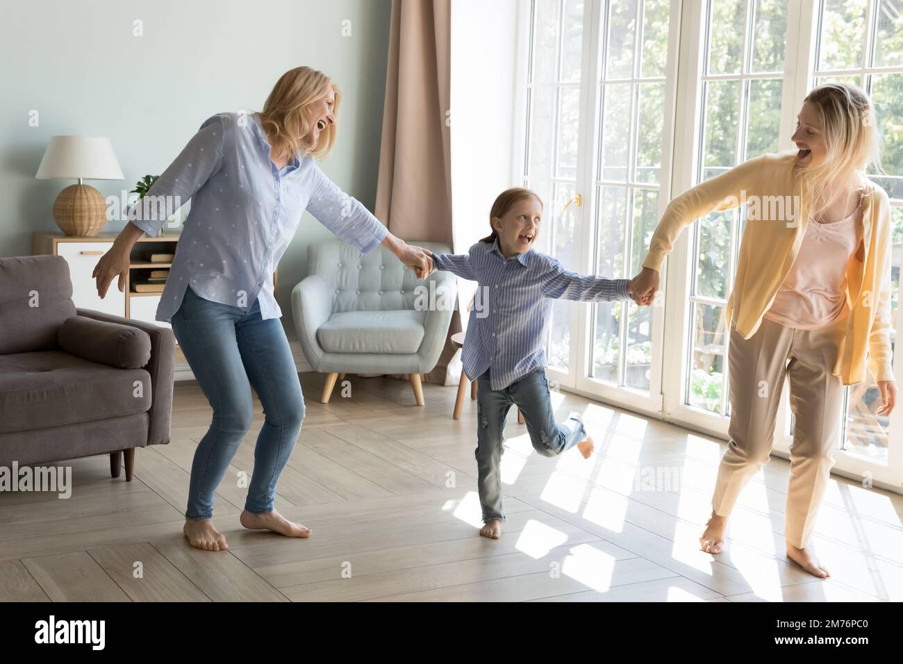 Excited cheerful mother, daughter kid and happy grandma having fun Stock Photo