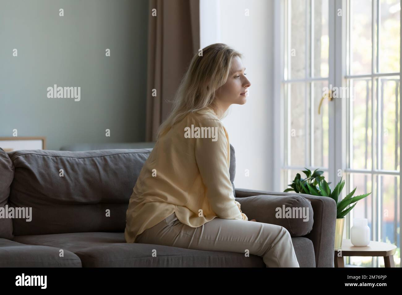 Pensive lonely sad young adult woman thinking on bad new Stock Photo