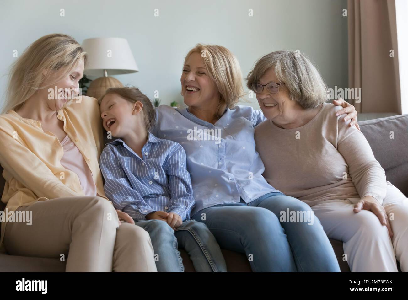 Joyful happy girls and women of different ages laughing Stock Photo