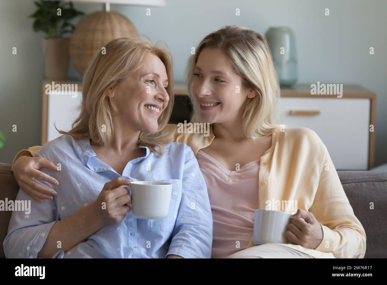 Positive young adult daughter woman and happy middle aged mom Stock Photo