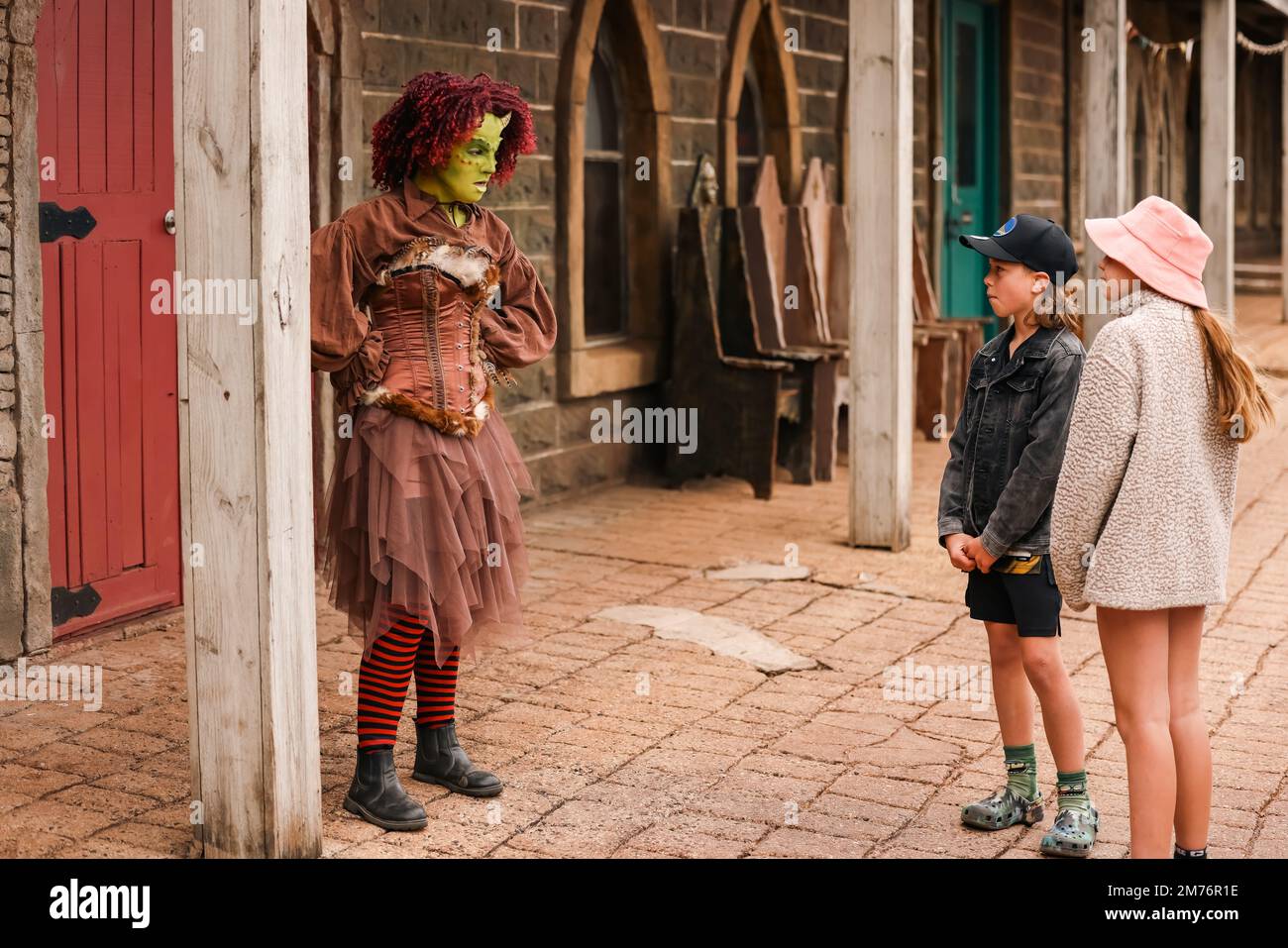 Children talking to female ogre at Kryal Castle, Ballarat Australia Stock Photo