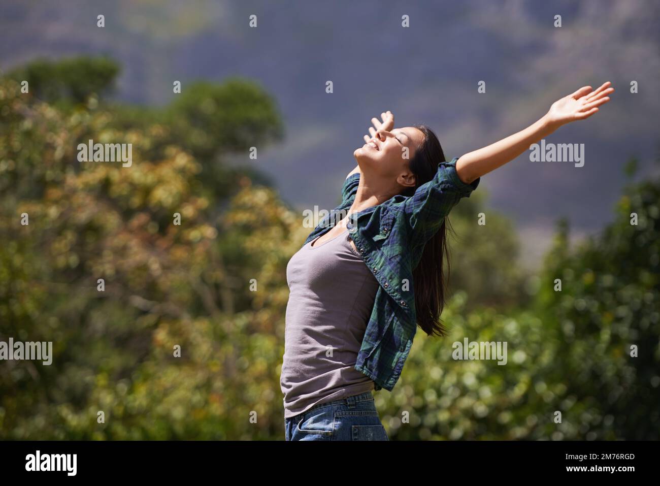 Leaving herself wide open. Portrait of an attractive young woman celebrating the day outside. Stock Photo