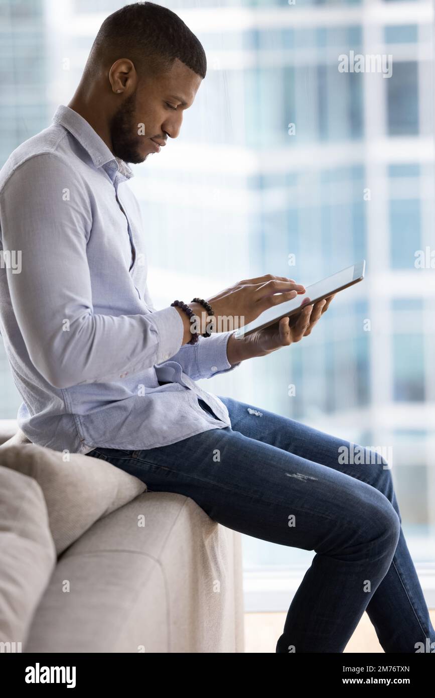 African businessman working on on-line project using digital tablet Stock Photo