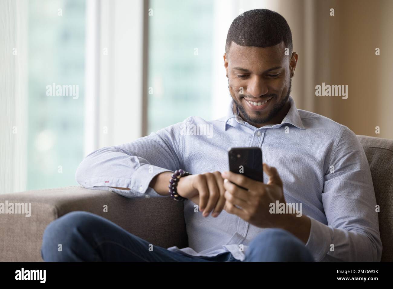 Handsome African man using modern smart phone Stock Photo