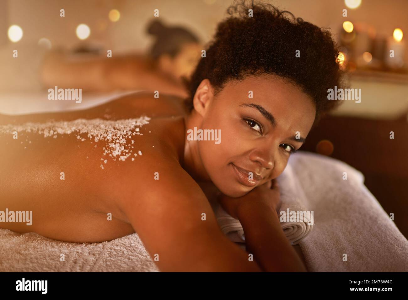 Everyday should be a spa day. a young woman enjoying a salt exfoliation treatment at a spa. Stock Photo