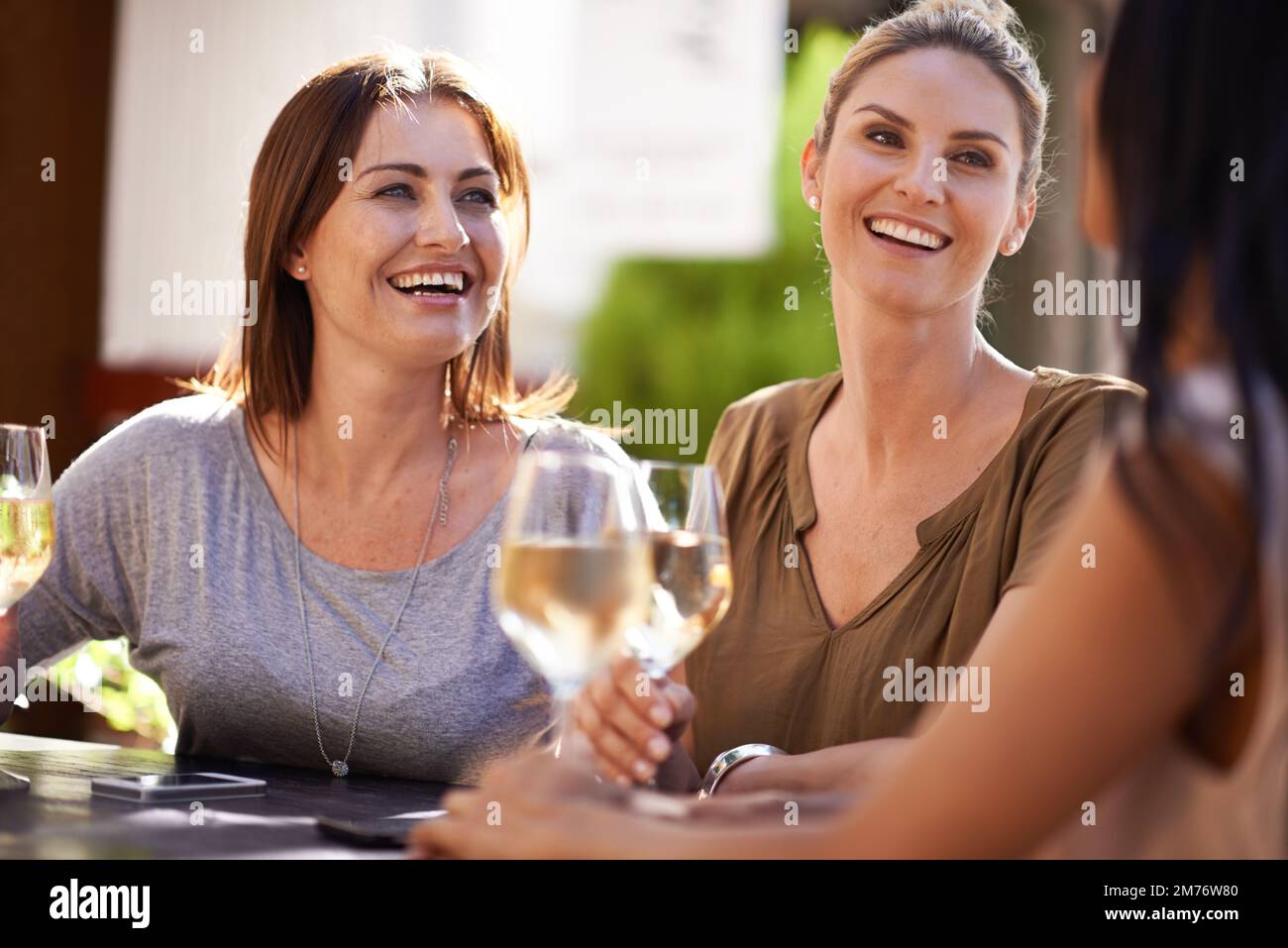 Winding down together after work. a happy group of friends having a drink together. Stock Photo