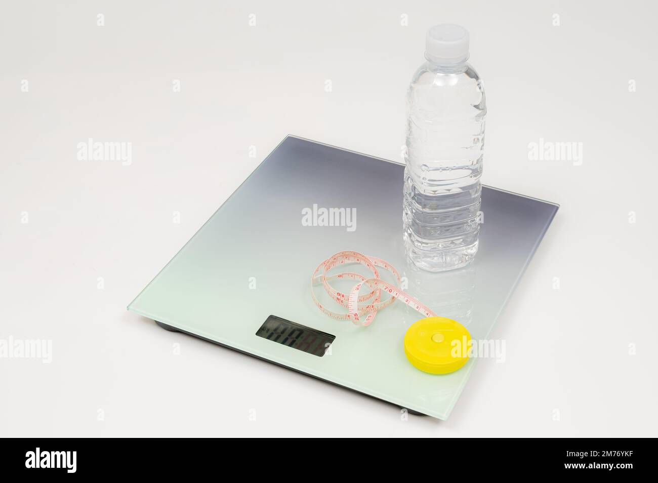 Weight scale, tape measure and water bottle isolated on white background Stock Photo