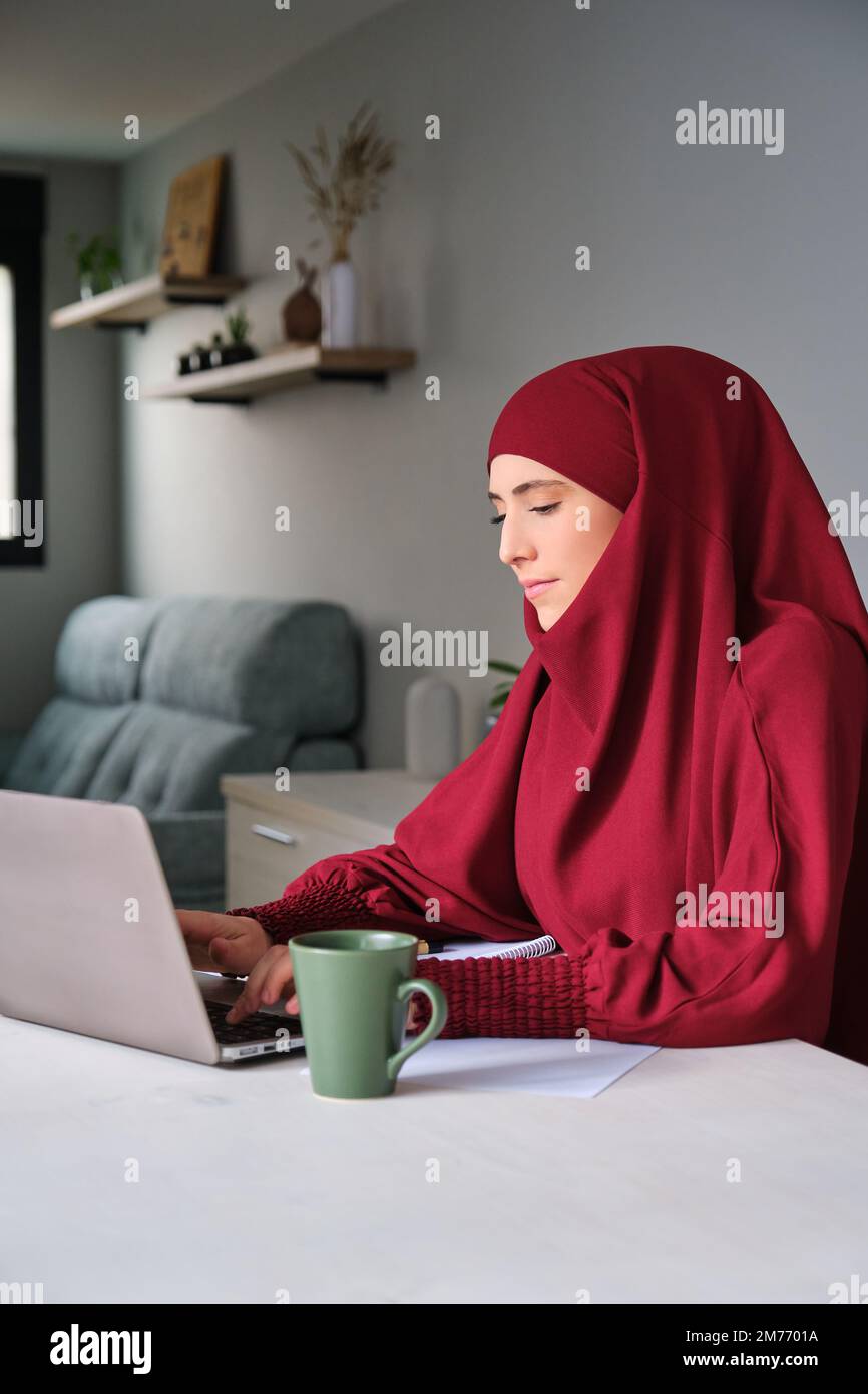 Muslim young woman in hijab using laptop at home Stock Photo - Alamy