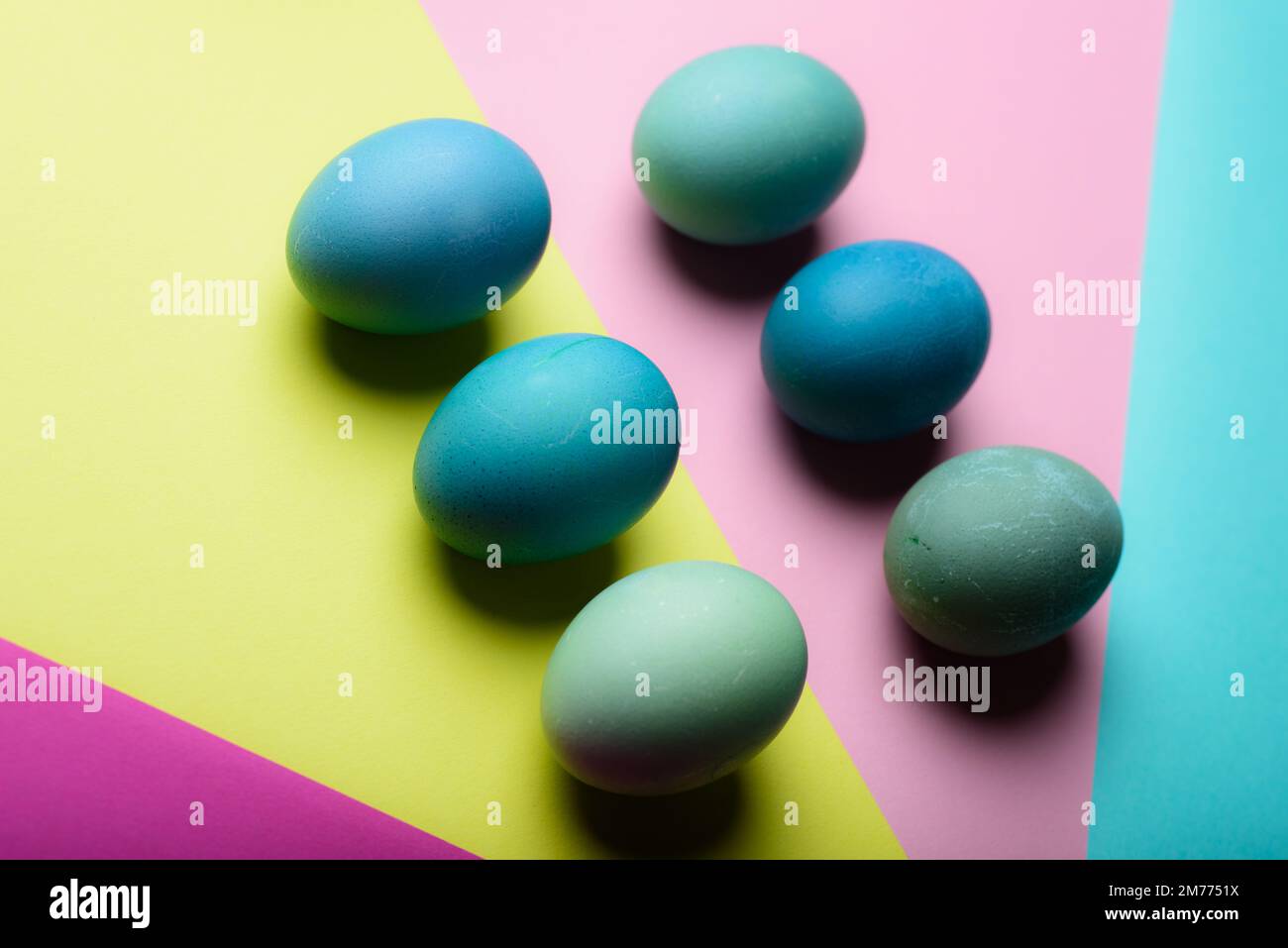 Happy Easter pastel coloured background. Hand painted Easter eggs abstract minimal concept. Stock Photo