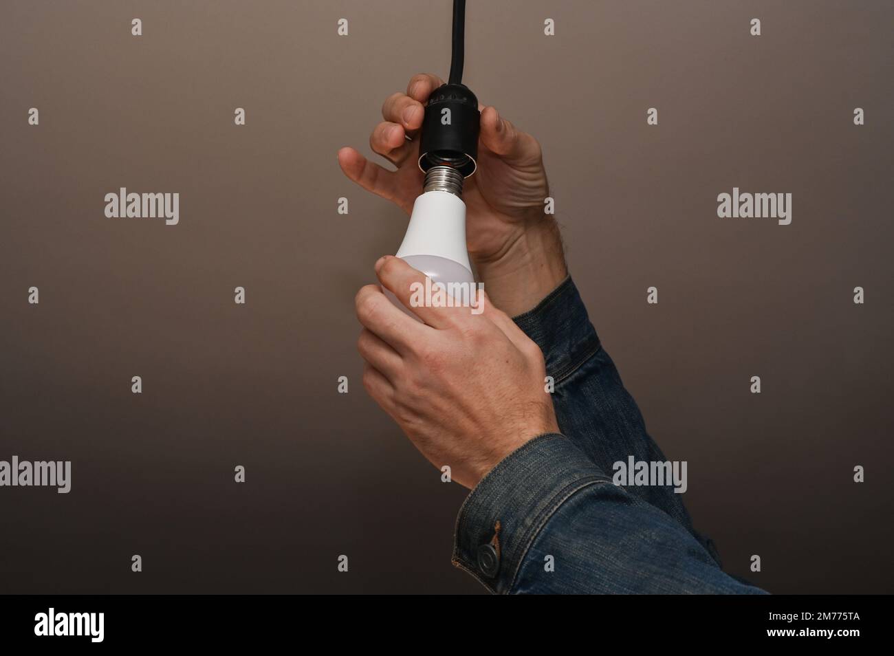 Replacing the lamp with LED lamps. concept of energy saving. Stock Photo