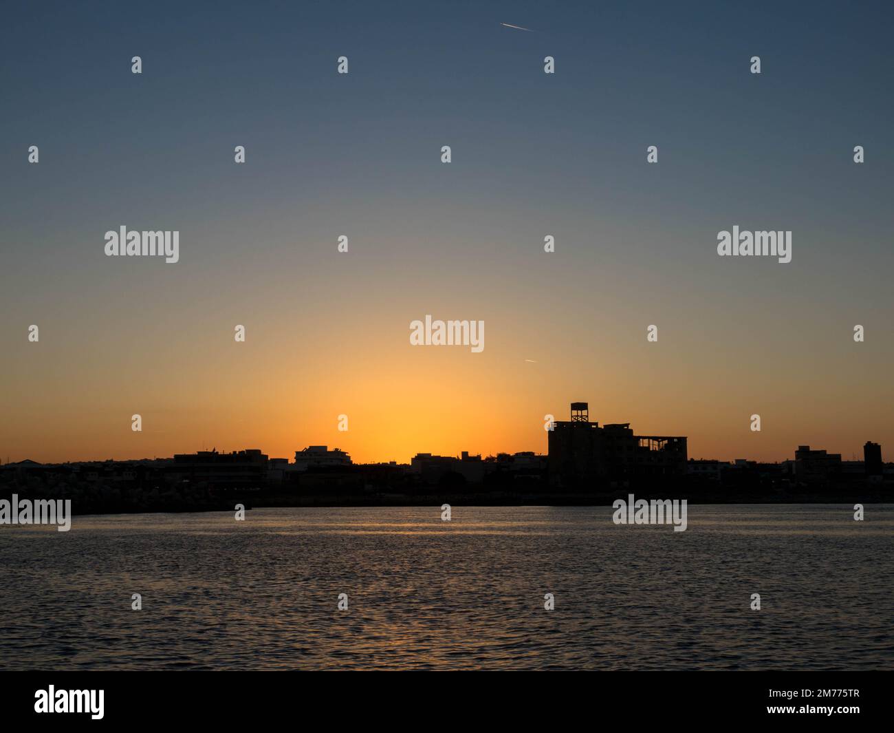 Panoramic view. Sunset over Rhodes town and port. Beautiful sky with space for text. Stock Photo