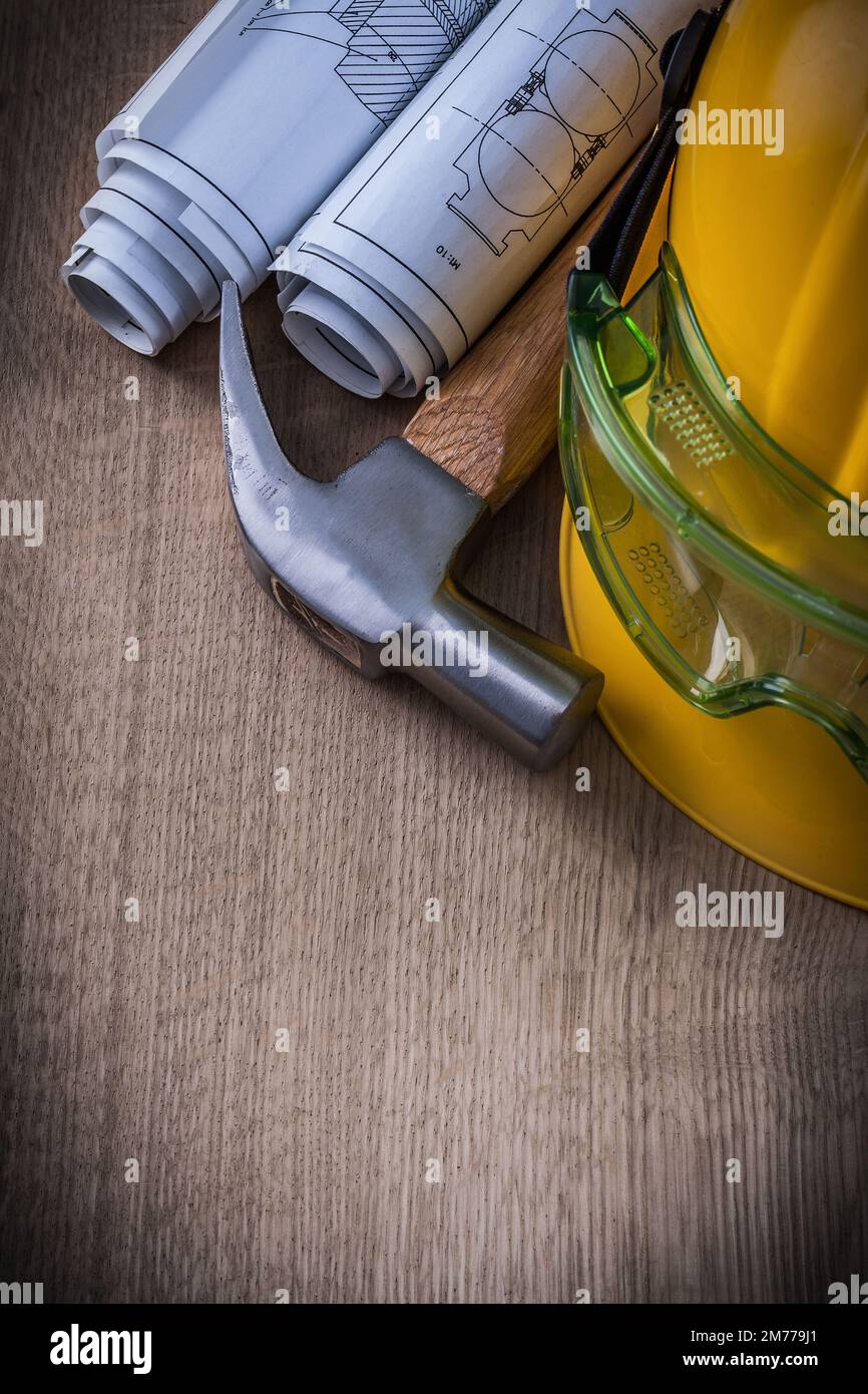 Claw hammer safety goggles construction plans and protective cap. Stock Photo