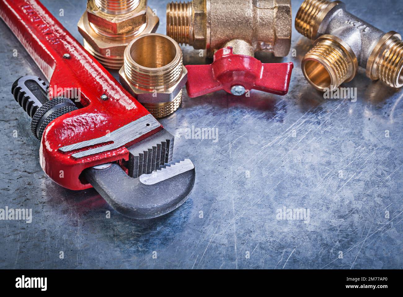 Monkey wrench brass plumbing fittings gate valve on metallic background