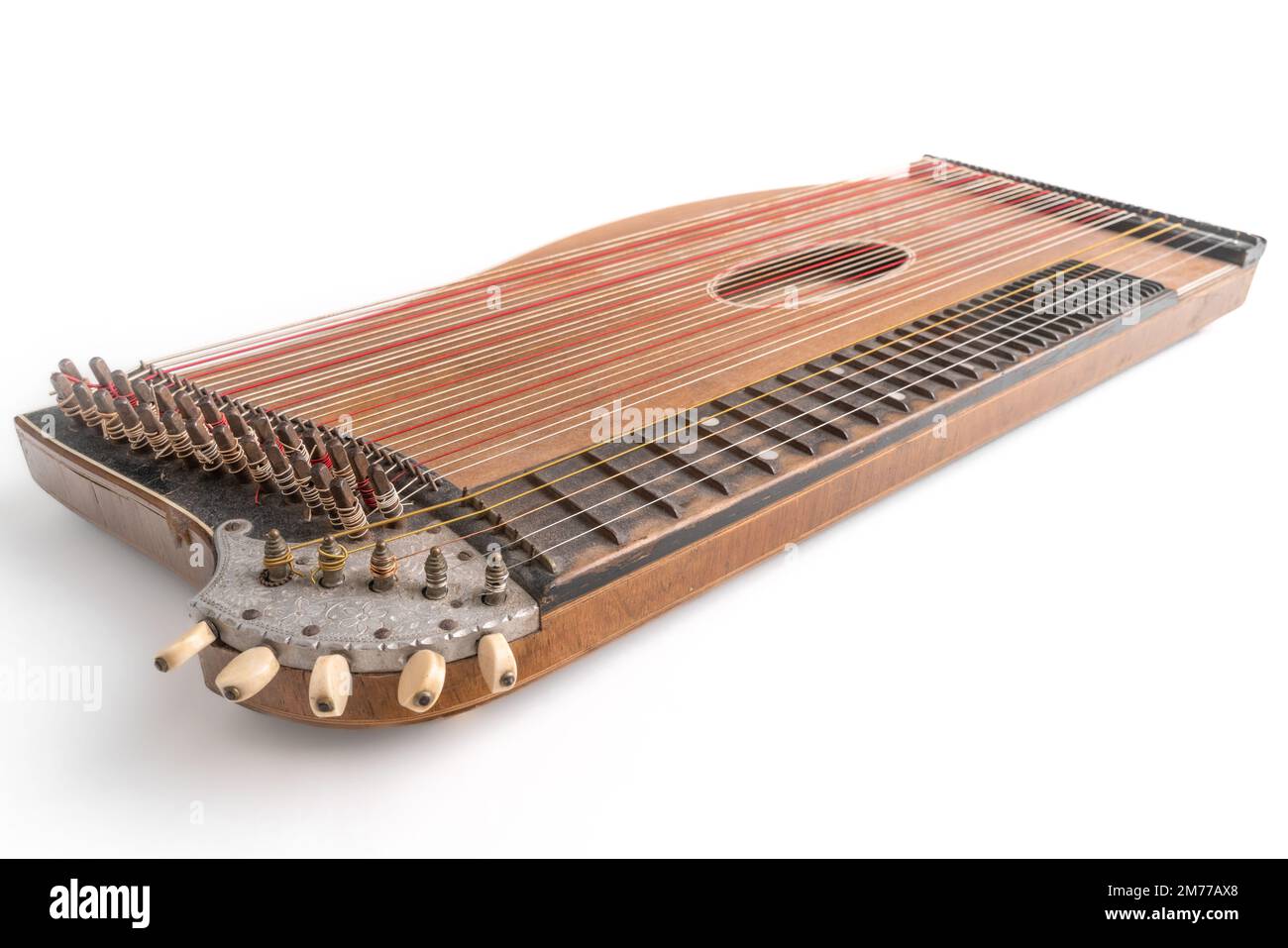 High angle closeup horizontal studio shot of vintage, old wooden zither isolated on white