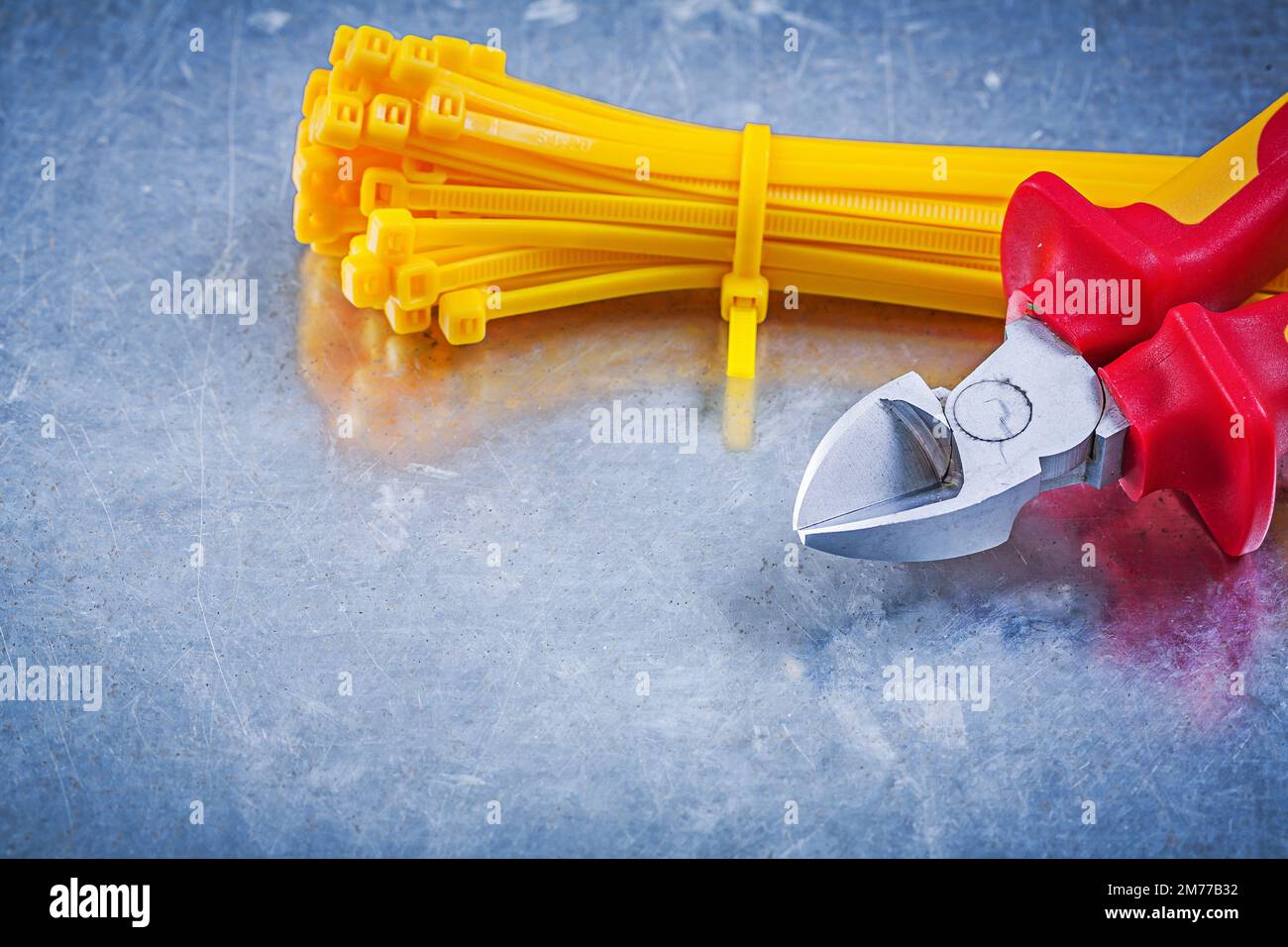 Nippers cable ties on metallic background construction concept. Stock Photo