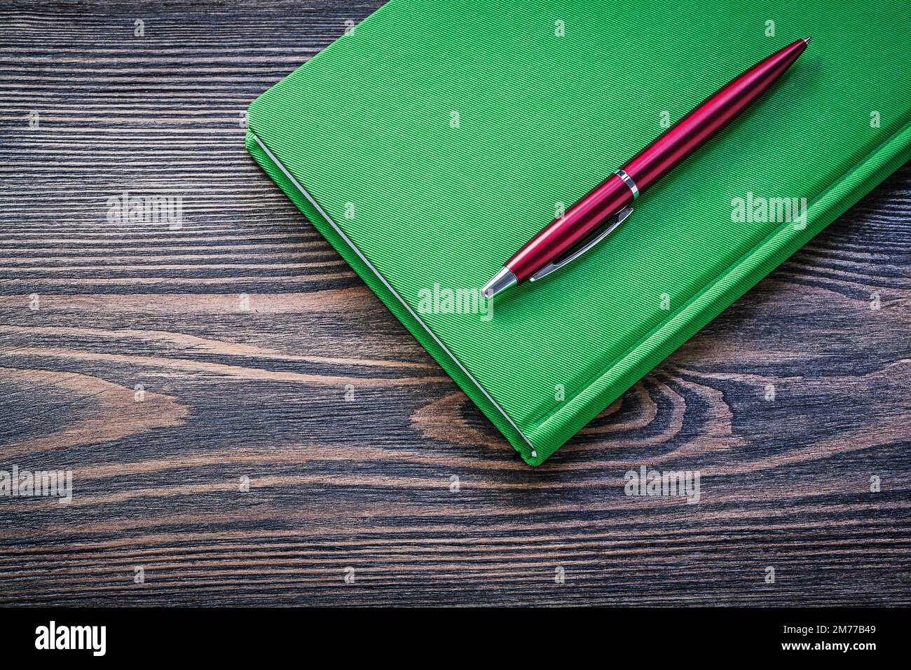 Notepad ball-point pen on wooden board education concept. Stock Photo