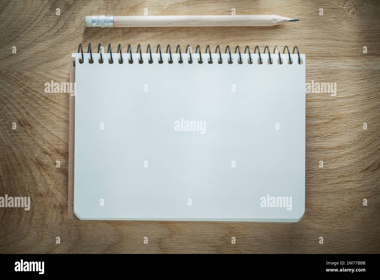 Opened notepad pencil on wooden board. Stock Photo