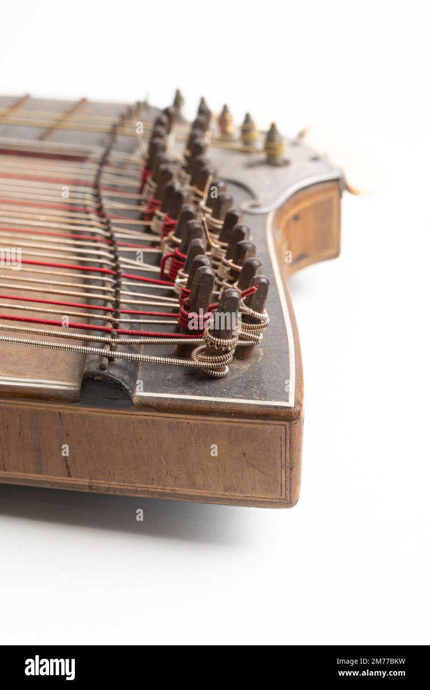High angle vertical studio shot of vintage, old wooden zither isolated